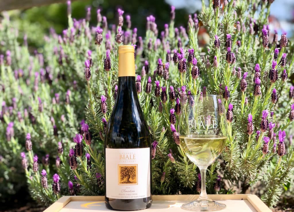 2019 Clementina White Wine bottle from Robert Biale Vineyards with glass of wine next to bottle with Biale logo, background of lavender