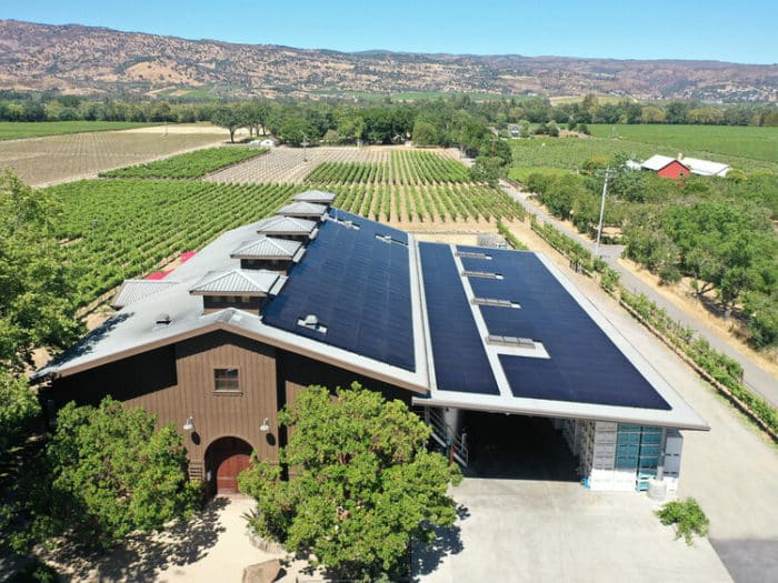 Aerial view of Biale winery with solar panels with vineyards and mountains in background