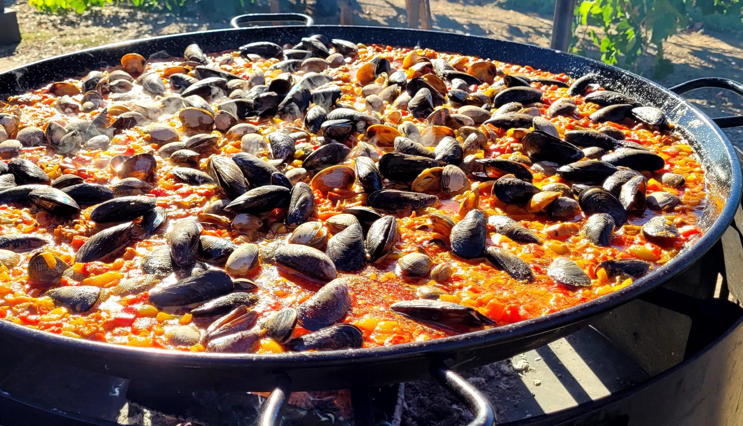 large paella pan over the fire