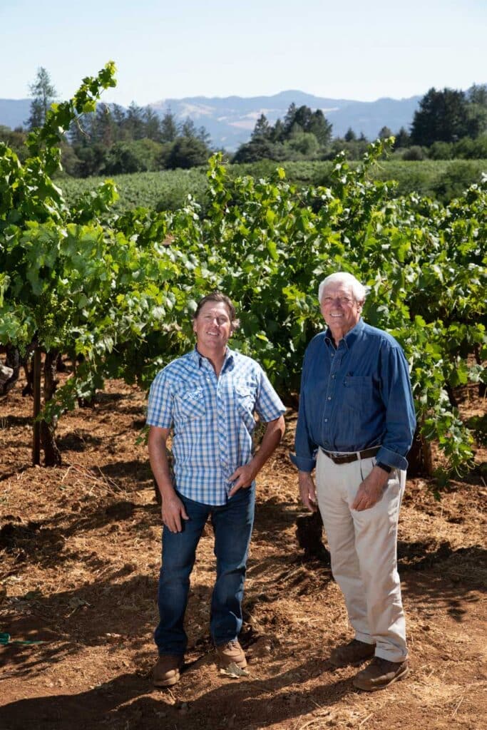 Patrick and Mike Beatty stand among the zinfandel vines at Beatty Ranch
