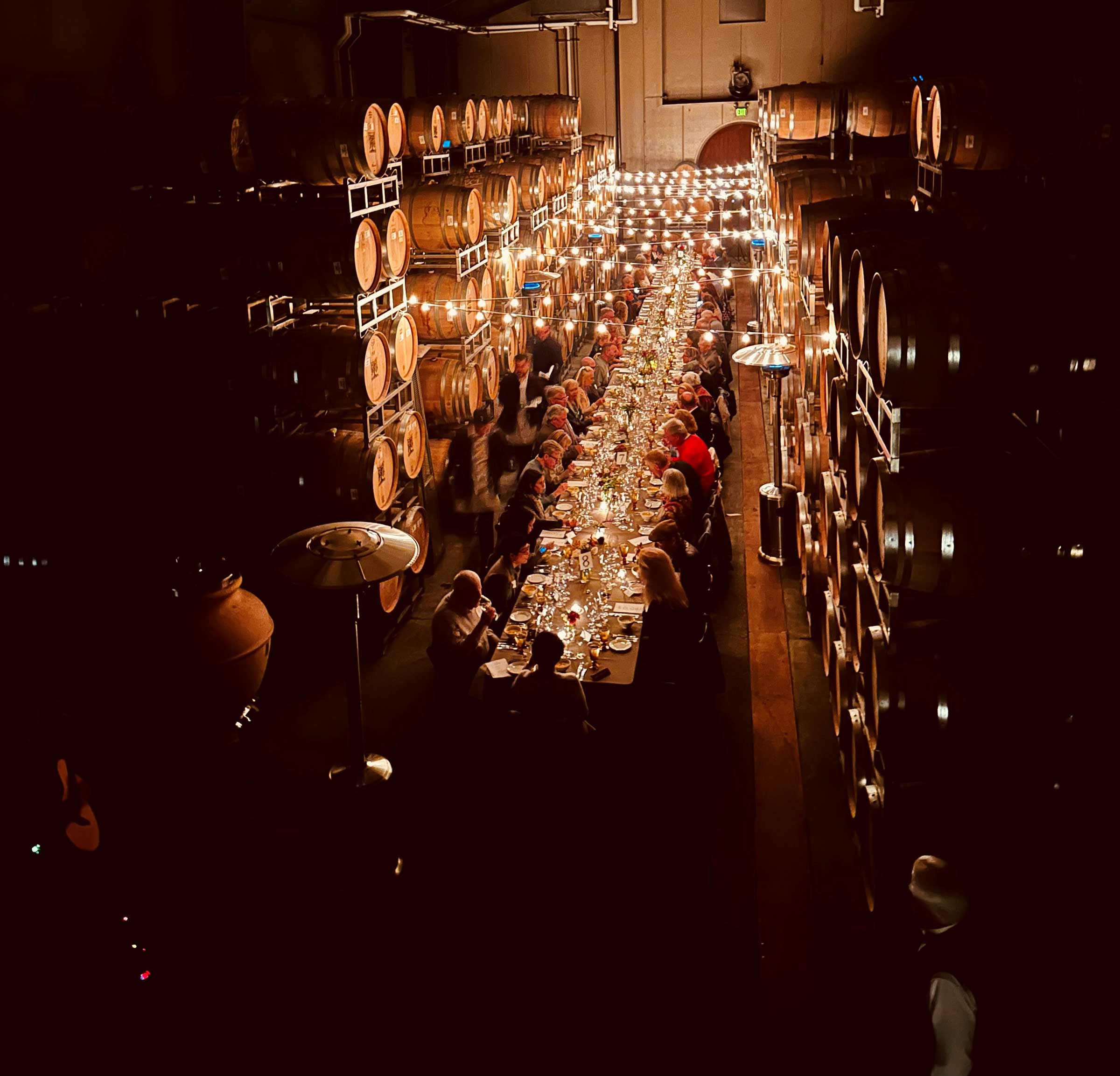 looking down in the Biale wine cellar with barrels surrounding a long banquet table