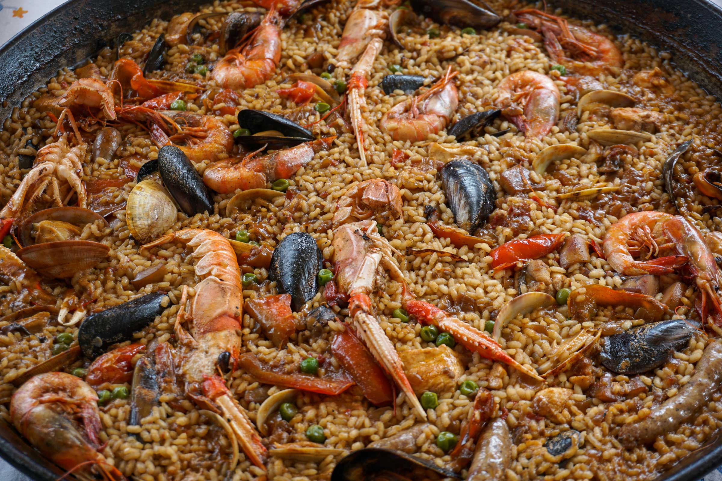 paella in a large pan with shrimp, mussels and other seafood